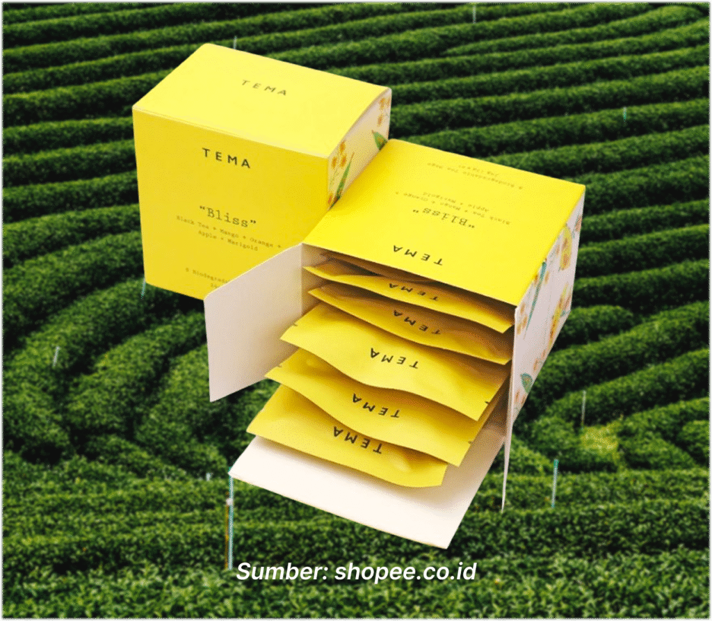 Box teh berwarna kuning "Bliss- Black Mango Tea" dari TEMA