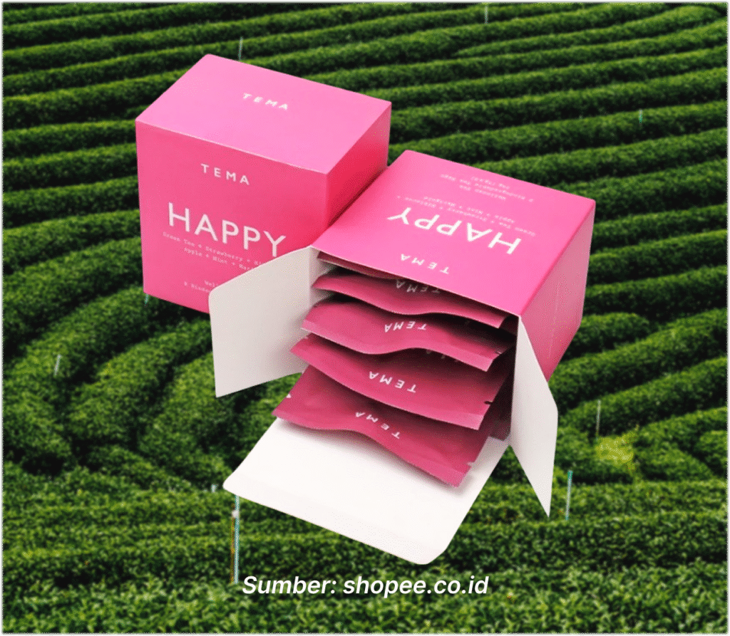 Box teh berwarna pink "Happy - Green Strawberry Tea" dari TEMA